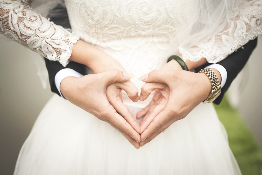 Wedding loans in Canada - a couple holding hands in a heart-shape form