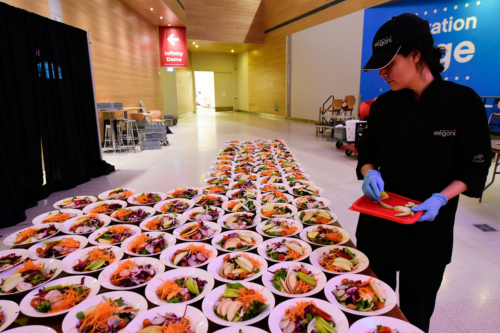 Simply Elegant team member is preparing a corporate event catering order at Telus Spark in Calgary
